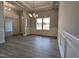 Formal dining room featuring wainscoting, crown molding, modern light fixture, and a large window at 639 Sweet Potato Lane # 3, Nashville, NC 27856