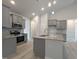 Stylish kitchen boasts gray cabinets, stainless steel appliances, granite countertops, and a central island at 639 Sweet Potato Lane # 3, Nashville, NC 27856