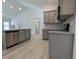 Modern kitchen featuring gray cabinets, stainless steel dishwasher, granite countertops, and a vaulted ceiling at 639 Sweet Potato Lane # 3, Nashville, NC 27856