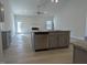 Spacious living room with a fireplace, ceiling fan, neutral paint, and luxury vinyl plank flooring at 639 Sweet Potato Lane # 3, Nashville, NC 27856
