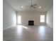 Bright living room features a modern fireplace, fan, white trim, and vinyl plank flooring at 639 Sweet Potato Lane # 3, Nashville, NC 27856