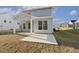 View of the back of the house with a covered patio and spacious yard at 82 Gander Dr, Benson, NC 27504