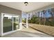 View of the covered patio with large windows and a sliding glass door at 82 Gander Dr, Benson, NC 27504