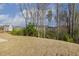 View of the backyard showing the gentle slope and tree line at 82 Gander Dr, Benson, NC 27504