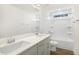 A modern bathroom features double sinks with a white countertop and a shower over tub at 82 Gander Dr, Benson, NC 27504