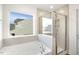 Beautiful new bathroom includes a soaking tub and glass shower, with a view of the neighborhood at 82 Gander Dr, Benson, NC 27504