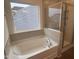 Bathtub with tile surround with a view and a glass-enclosed shower at 82 Gander Dr, Benson, NC 27504