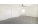 Well lit bedroom with plush carpet, tray ceiling, fan, and multiple doors at 82 Gander Dr, Benson, NC 27504