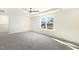 Bright bedroom featuring plush carpet and a large window with a neighborhood view at 82 Gander Dr, Benson, NC 27504