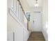 Bright entryway features a white door, staircase, and wainscoting at 82 Gander Dr, Benson, NC 27504