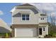 Charming two-story home featuring a brick-accented garage, light gray siding, and a well-manicured lawn at 82 Gander Dr, Benson, NC 27504