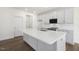 Kitchen featuring white cabinets, stainless appliances, and an island with a sink at 82 Gander Dr, Benson, NC 27504