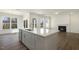 Open-concept kitchen with stainless appliances, hardwood floors and an island with sink at 82 Gander Dr, Benson, NC 27504