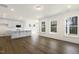 Open-concept living space with hardwood floors, white cabinets, and ample natural light at 82 Gander Dr, Benson, NC 27504