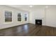 Bright living room features a fireplace, hardwood floors, and large windows overlooking a scenic view at 82 Gander Dr, Benson, NC 27504