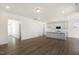 Spacious open-concept living space with hardwood floors, white cabinets, and neutral wall colors at 82 Gander Dr, Benson, NC 27504