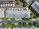 Bird's eye view shows landscaping and parking surrounding townhomes at 128 Dove Cottage Ln, Cary, NC 27519