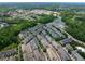 Aerial view showing community gardens, playground, tennis courts, and townhomes at 128 Dove Cottage Ln, Cary, NC 27519