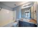 Full bathroom offers a combined shower-tub and a vanity with storage at 128 Dove Cottage Ln, Cary, NC 27519