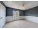 Comfortable bedroom with wainscotting, ceiling fan, and a bright window at 128 Dove Cottage Ln, Cary, NC 27519
