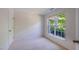 Neutral bedroom has a large window allowing natural light and closet space at 128 Dove Cottage Ln, Cary, NC 27519