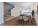 Inviting dining area with modern chandelier adjacent to the kitchen and stairway at 128 Dove Cottage Ln, Cary, NC 27519