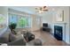 Relaxing living room offers a comfortable sofa, fireplace, and natural light at 128 Dove Cottage Ln, Cary, NC 27519