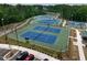 Aerial view of the community tennis courts surrounded by trees at 128 Dove Cottage Ln, Cary, NC 27519