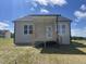 Rear view of home featuring a covered patio, large windows, and spacious yard with ample sunlight at 234 Danube Dr, Zebulon, NC 27597