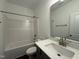 Clean bathroom with a tub-shower combo and a vanity with a white countertop at 234 Danube Dr, Zebulon, NC 27597