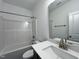 This bathroom has a tub and shower, toilet, mirror, and a vanity sink with white countertop at 234 Danube Dr, Zebulon, NC 27597