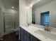 Modern bathroom with double sinks, quartz countertops, and a glass-enclosed shower at 234 Danube Dr, Zebulon, NC 27597