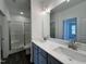 Bathroom featuring double vanity with modern faucets, lighting, and a separate tiled shower at 234 Danube Dr, Zebulon, NC 27597