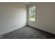 Bright bedroom features a large window, neutral paint, and plush gray carpeting at 234 Danube Dr, Zebulon, NC 27597