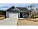 Charming single-Gathering home with a two-car garage and a well-manicured lawn on a sunny day at 234 Danube Dr, Zebulon, NC 27597