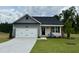 Charming single-Gathering home boasts a well-manicured lawn and a welcoming two-car garage at 234 Danube Dr, Zebulon, NC 27597