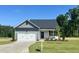 Charming single-Gathering home with a one car garage, landscaped front yard, and covered front porch at 234 Danube Dr, Zebulon, NC 27597