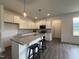 Modern kitchen featuring white cabinets, stainless steel appliances, and a granite island at 234 Danube Dr, Zebulon, NC 27597
