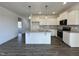 Bright kitchen features white cabinets, granite countertops, stainless steel appliances, and an island at 234 Danube Dr, Zebulon, NC 27597