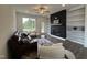 Cozy living room with a fireplace, built-in shelving, and comfortable seating at 234 Danube Dr, Zebulon, NC 27597
