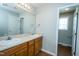 This bathroom includes a double vanity, mirror, and natural-colored cabinets at 310 E Horton St, Zebulon, NC 27597