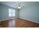 Inviting bedroom with modern ceiling fan, wood-look floors, and ample natural light at 310 E Horton St, Zebulon, NC 27597