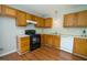 Traditional kitchen featuring wood cabinets, white countertops, and black appliances at 310 E Horton St, Zebulon, NC 27597