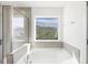 Bathroom with soaking tub and window overlooking backyard at 26 Steppe Way, Garner, NC 27529