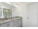 Double vanity bathroom with granite countertop and gray cabinets at 26 Steppe Way, Garner, NC 27529