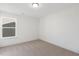 Bright bedroom with carpeted floor and large window at 26 Steppe Way, Garner, NC 27529