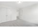 Well-lit bedroom featuring double doors and carpet at 26 Steppe Way, Garner, NC 27529