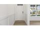 White entryway with wood-look floors and white door at 26 Steppe Way, Garner, NC 27529