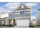 Two-story house with gray siding, white garage door, and landscaping at 26 Steppe Way, Garner, NC 27529
