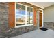 A window with orange shutters and stone exterior at 26 Steppe Way, Garner, NC 27529